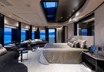 large bed faces panoramic windows in the master suite aboard charter yacht SOLO