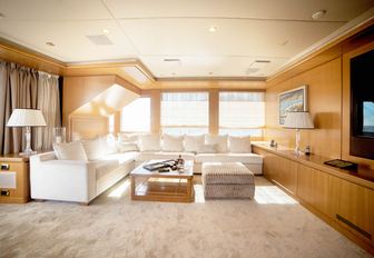 L-shaped sofa faces widescreen TV in the skylounge aboard superyacht OASIS