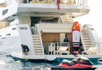 water toys spread out on the beach club of motor yacht K