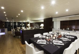 formal dining area and lounge in main salon of charter yacht LIONSHARE 