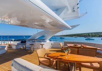 luxury yacht sundeck with dining and bar