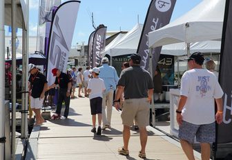 visitors stroll along the boardwalks looking at exhibitors at Miami Yacht Show