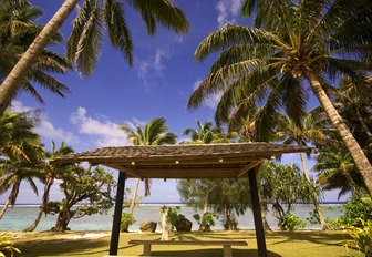 A couple sit under a pagoda in the Cook Islands