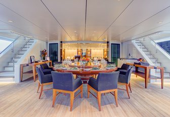 circular alfresco dining table on the upper deck aft of charter yacht Party Girl