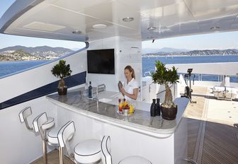 serving cocktails on the sundeck bar of luxury yacht ‘Zoom Zoom Zoom’ 