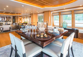 square dining table in the main salon of luxury yacht HANIKON 