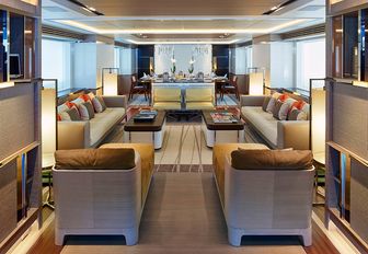 library nook with seating and dining areas beyond in the main salon aboard luxury yacht ASYA 