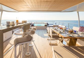 bar, dining table and Jacuzzi on sundeck of charter yacht NARVALO 