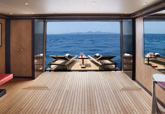 Two sunloungers rest on the balcony which extends off superyacht 'Alfa Nero'