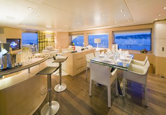 formal dining area next to bar in the main salon of superyacht  SALU