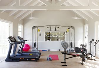 gym in villa of thanda island, with treadmills and other gym equipment