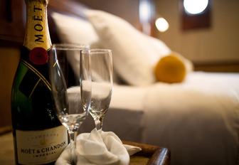 bottle of Moet on the bedside table in the master suite of superyacht GRACE 