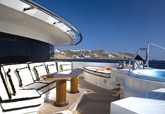 Chairs lining the exterior of the bridge of superyacht 'Alfa Nero' with the Jacuzzi to the right of the frame