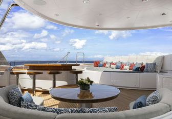 seating areas and spa pool with swim-up bar on the sundeck of luxury yacht Broadwater