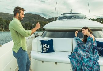guests take a photo on the foredeck seating area aboard luxury yacht THEORIS 