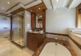 spacious master suite en-suite bathroom with shower and bath tub
