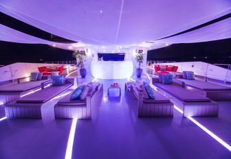 Sundeck lit up at night to create party atmosphere on charter yacht SALUZI