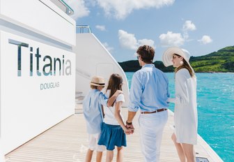 family arrive on the swim platform of motor yacht TITANIA