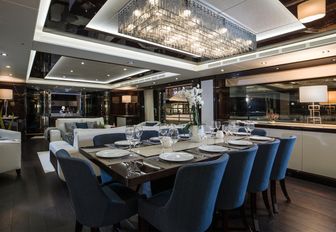 dining table under Murano glass chandelier in main salon aboard superyacht FLEUR