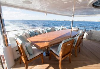 lounging and dining area on main deck aft of charter yacht SERENITY