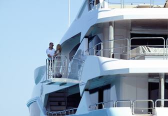 guests take some time alone on the upper deck port-side balcony aboard charter yacht ARADOS