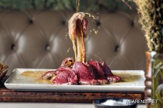 Steak dish with sauce being poured on