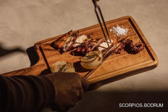 Chef at Scorpios Bodrum cutting chicken
