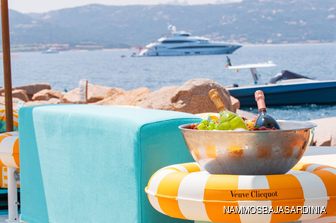 Nammos Baja Sardinia views with luxury yacht charter visible