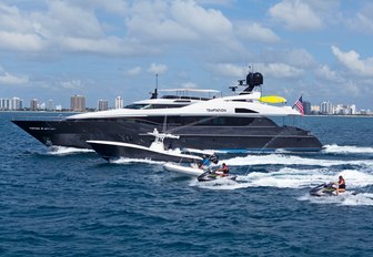 motor yacht Temptation cuts through water with water toys on a charter vacation