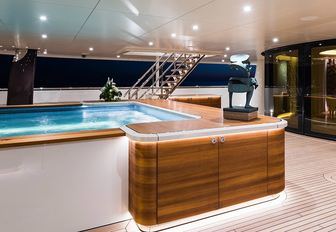 recessed swimming pool on the main deck aft of luxury yacht ‘Here Comes The Sun’ 