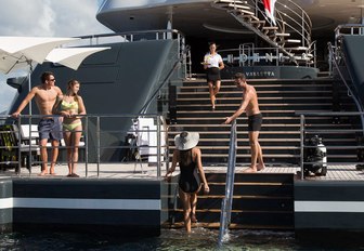 charter guests gather on the large swim platform of luxury yacht PHOENIX 2