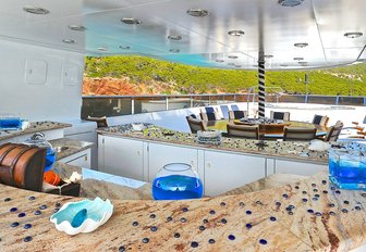 marble-topped bar with dining table beyond on the sundeck of charter yacht ‘Ionian Princess’ 