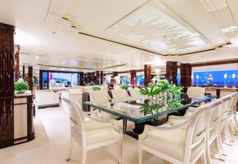 glass topped table forms formal dining area in main salon of charter yacht ‘Lioness V’ 