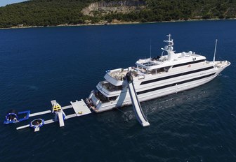 motor yacht KATINA anchors on charter alongside her water toys