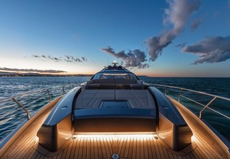 Sunpad on motor yacht BEYOND at sunset with lighting emanating from teak deck