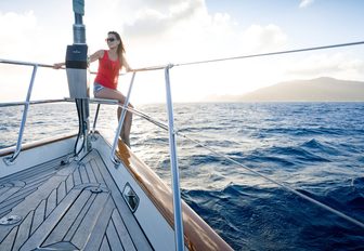 charter guest takes in the views from the stern aboard luxury yacht MARAE