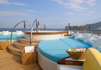 Step-up Jacuzzi surrounded by sunpads on the forward section of the sundeck aboard motor yacht OASIS 