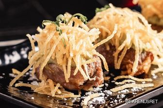 Steak sushi dish on black plate