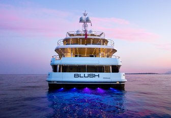 view of stern on motor yacht BLUSH as the sun sets over the horizon