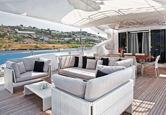sumptuous sofa and armchair back the alfresco dining area aboard luxury yacht ‘Tutto Le Marrané’