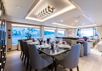 sophisticated dining area in main salon aboard luxury yacht ONEWORLD