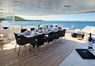 alfresco dining setup on the upper deck aft of luxury yacht Take 5