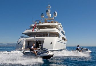charter yacht LATITUDE anchors as two guests take to the jet skis