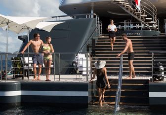 guests flock to the large swim platform on board luxury yacht Phoenix 2