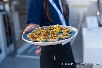 Waitress holding plate of appetizers