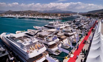 Elevated view looking down over MEDYS and superyacht charters berthed along dock with red carpet