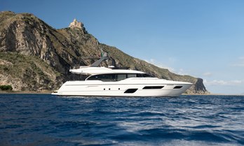 Charter yacht SEA SONS at anchor by cliffs