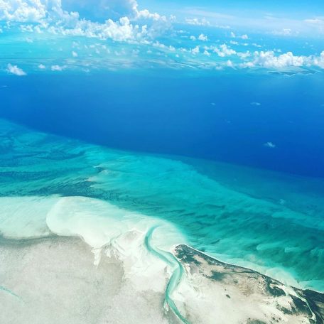 View from above of reef's white sand and clear blue water