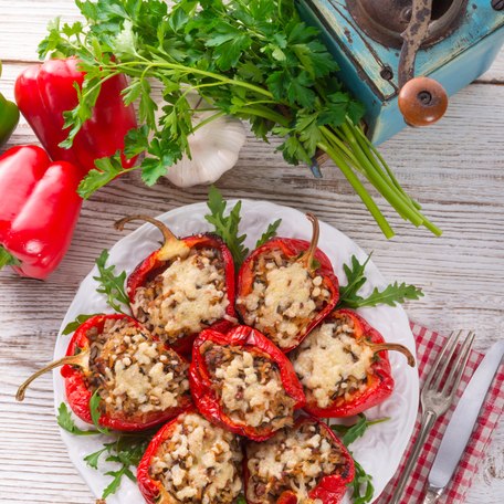 Stuffed red peppers on a wooden table
