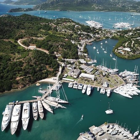 Overhead view of a marina in the Caribbean, multiple motor yachts berthed